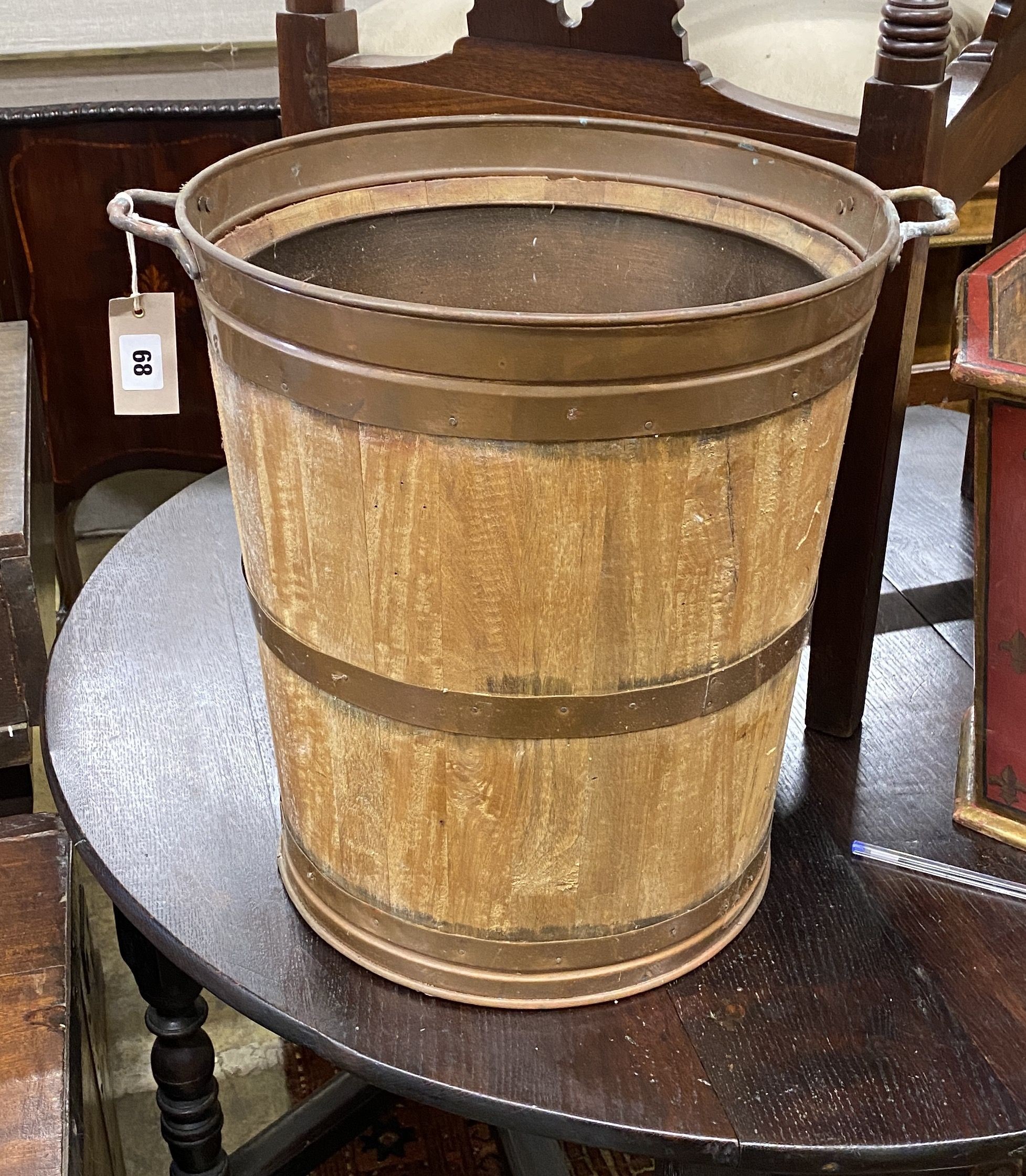 A copper bound and staved oak bucket, diameter 38cm, height 43cm
